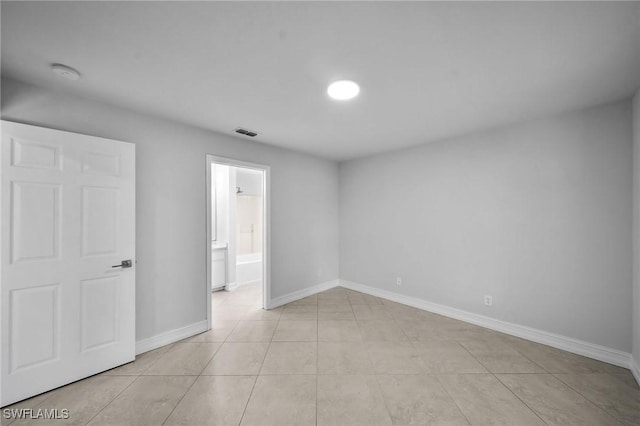 spare room featuring light tile patterned flooring