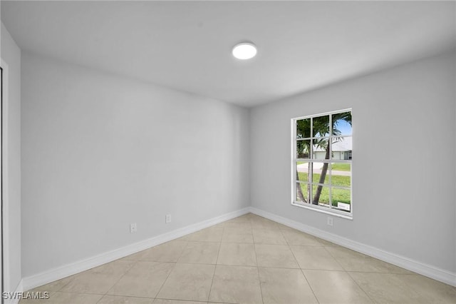 unfurnished room featuring light tile patterned floors