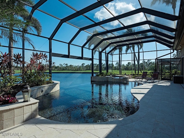 view of pool with a lanai, a patio area, a water view, and an in ground hot tub