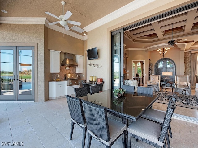 dining room featuring a towering ceiling, beamed ceiling, french doors, crown molding, and coffered ceiling