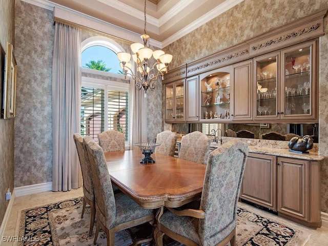 dining area featuring a chandelier, a high ceiling, and ornamental molding