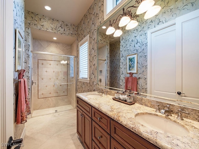 bathroom with tile patterned flooring, a shower with shower door, and vanity