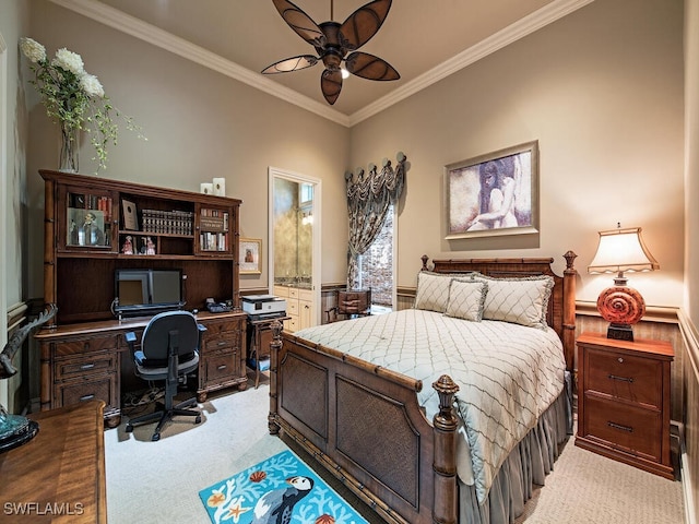 bedroom featuring ceiling fan, light colored carpet, connected bathroom, and ornamental molding