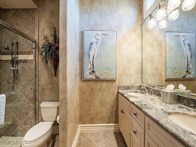 bathroom featuring toilet, vanity, and a tile shower