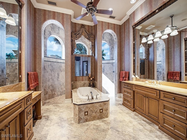 bathroom featuring ceiling fan, vanity, crown molding, and a relaxing tiled tub