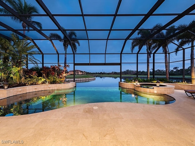 view of pool featuring a patio area, glass enclosure, a water view, and an in ground hot tub