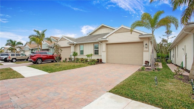 view of front of property with a front yard and a garage