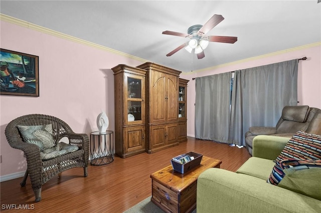 living room with hardwood / wood-style floors, ceiling fan, and crown molding