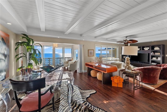 living room featuring dark wood-type flooring, beam ceiling, and ceiling fan