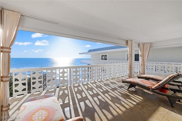 balcony with a beach view and a water view