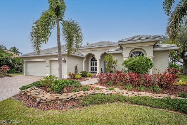 mediterranean / spanish-style home featuring a garage