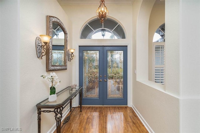 entryway featuring french doors, hardwood / wood-style floors, and a wealth of natural light