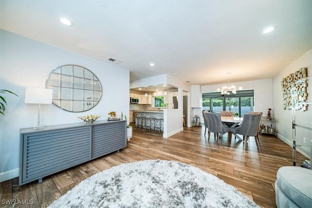 living room featuring hardwood / wood-style floors and a chandelier