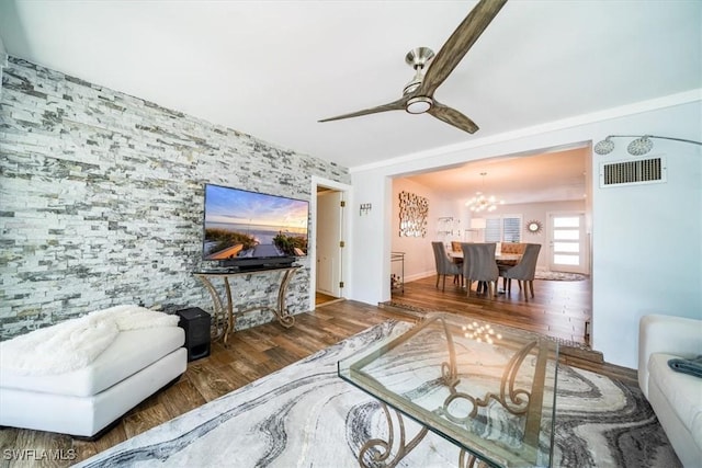 living room featuring dark wood-type flooring and ceiling fan