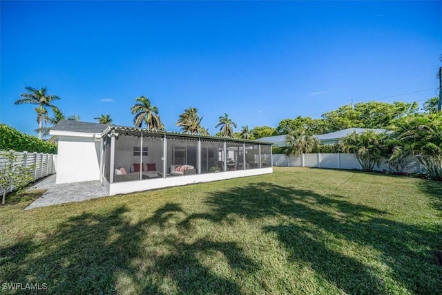 back of property featuring a lawn and a sunroom