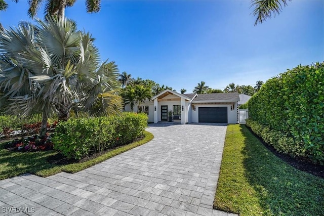 view of front of house featuring a front yard and a garage