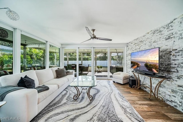 sunroom featuring ceiling fan