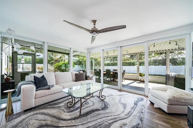 sunroom / solarium featuring ceiling fan