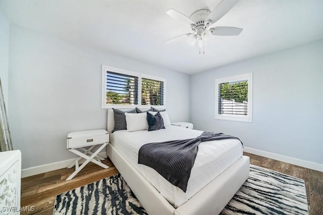 bedroom with dark wood-type flooring and ceiling fan