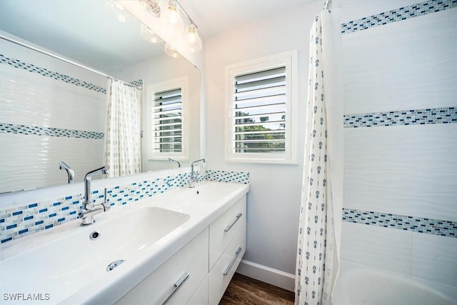 bathroom featuring vanity, backsplash, shower / bath combo with shower curtain, and hardwood / wood-style flooring