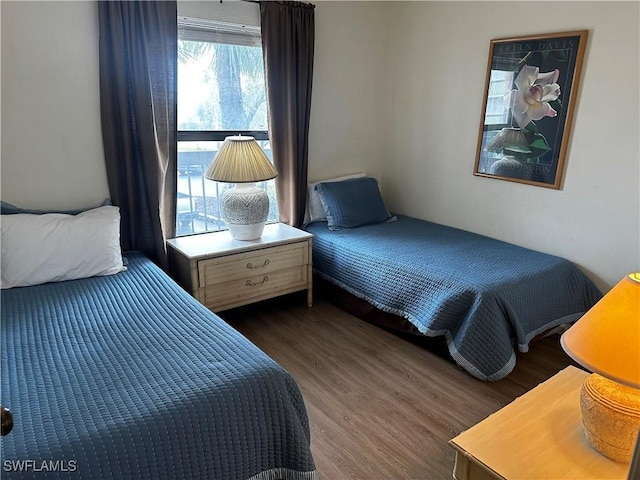 bedroom with dark hardwood / wood-style flooring