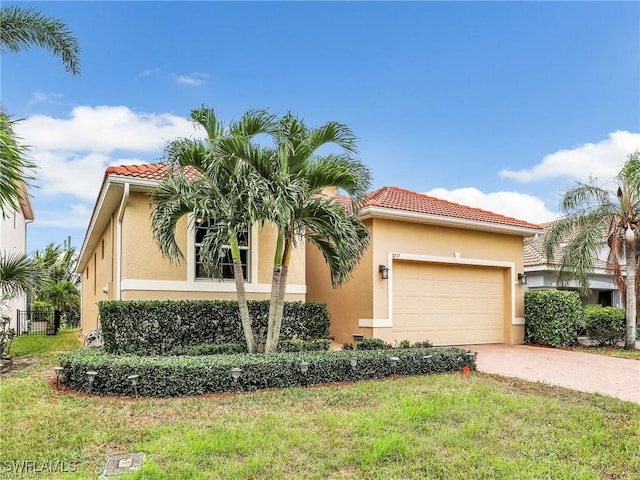 mediterranean / spanish-style home with a front lawn and a garage