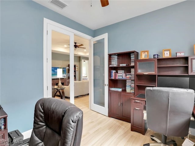 home office featuring ceiling fan, french doors, and light hardwood / wood-style flooring