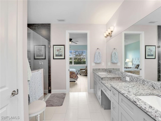 bathroom featuring tile patterned flooring, ceiling fan, a shower with shower door, and vanity