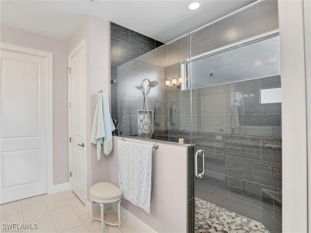 bathroom featuring tile patterned flooring and an enclosed shower