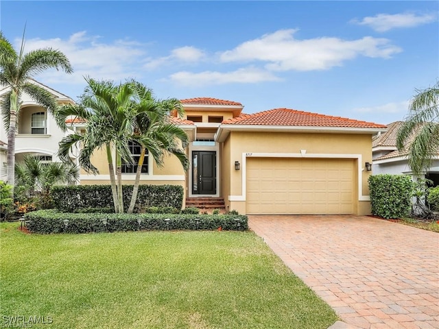 mediterranean / spanish house with a front yard and a garage