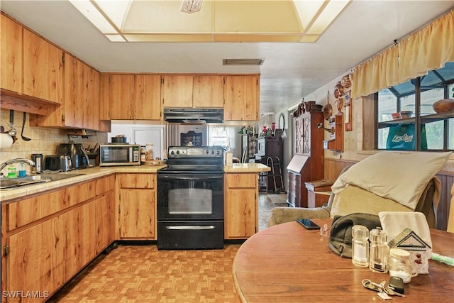 kitchen featuring sink, light parquet floors, black range with electric stovetop, and ventilation hood