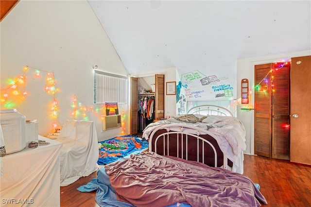 bedroom with lofted ceiling, a closet, and wood-type flooring