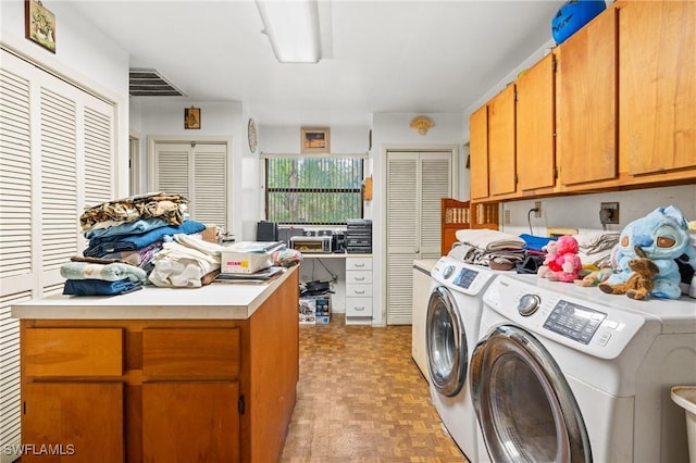 washroom with cabinets, independent washer and dryer, and light parquet flooring