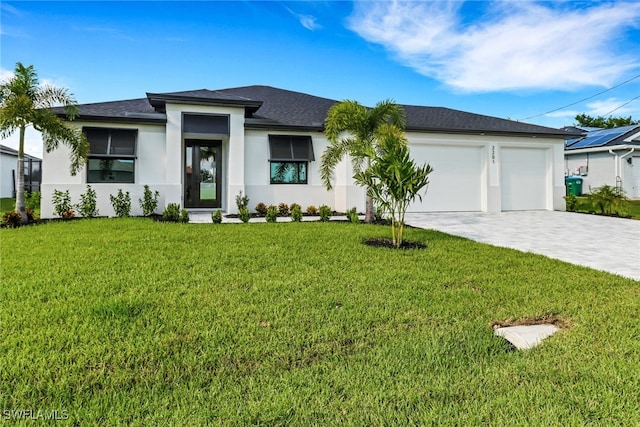 view of front of property with a garage and a front lawn