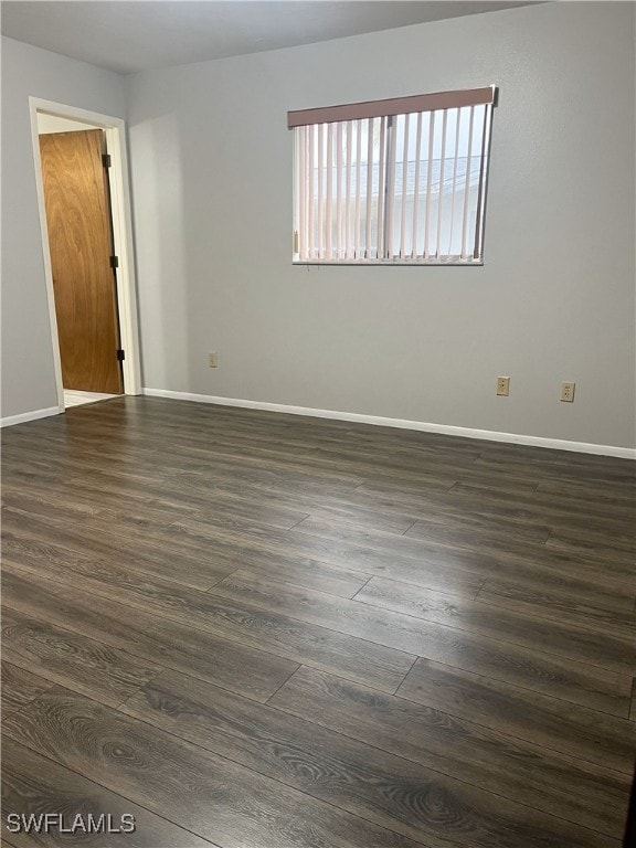 spare room with dark hardwood / wood-style floors