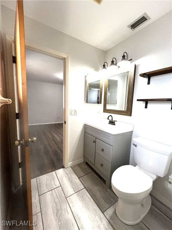 bathroom with toilet and vanity