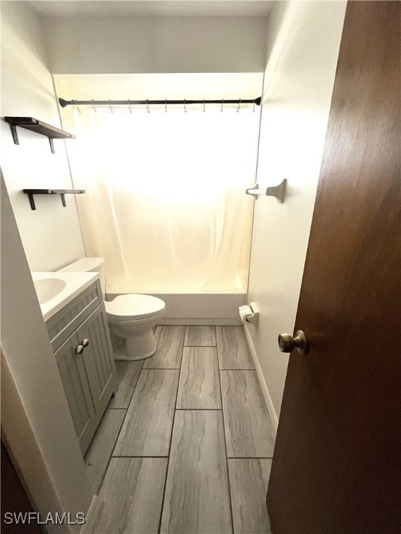 full bathroom featuring vanity, toilet, and shower / tub combo