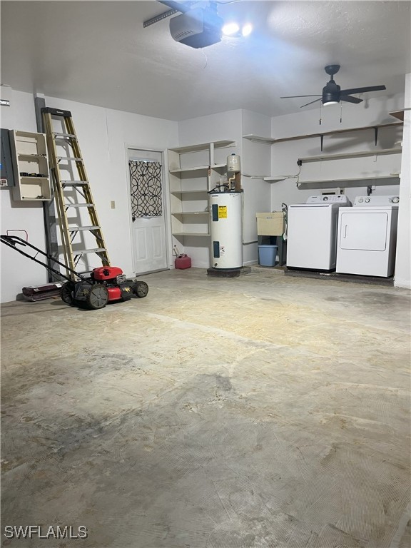 garage with electric water heater, a garage door opener, ceiling fan, and independent washer and dryer