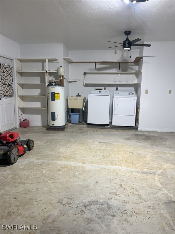 garage featuring sink, ceiling fan, washer and clothes dryer, and water heater