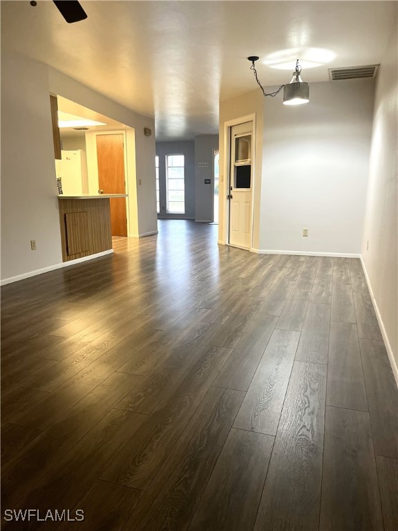 unfurnished living room featuring dark hardwood / wood-style floors