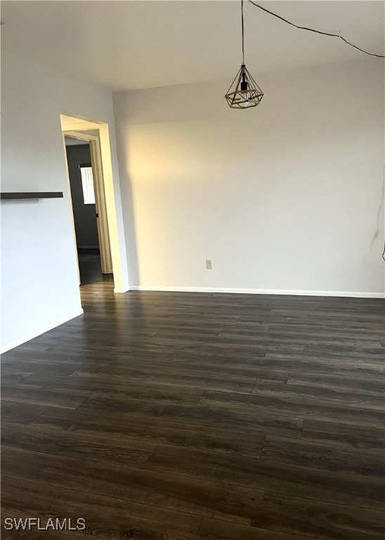 unfurnished room with dark hardwood / wood-style floors