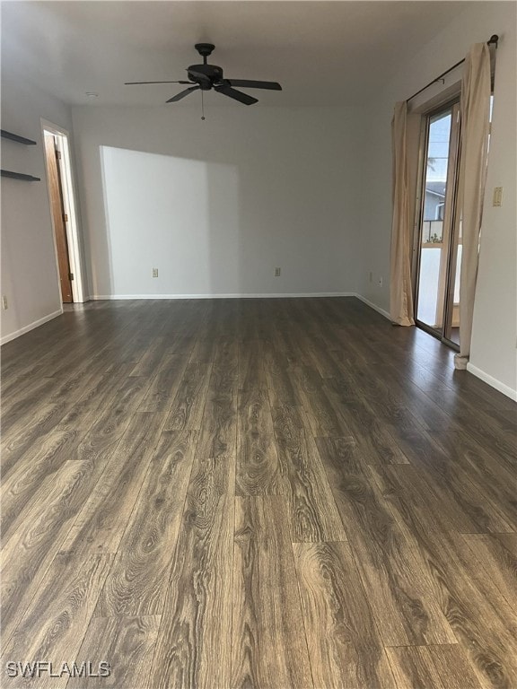 empty room with ceiling fan and dark hardwood / wood-style floors