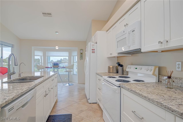 kitchen with light tile patterned flooring, white cabinetry, sink, light stone counters, and white appliances