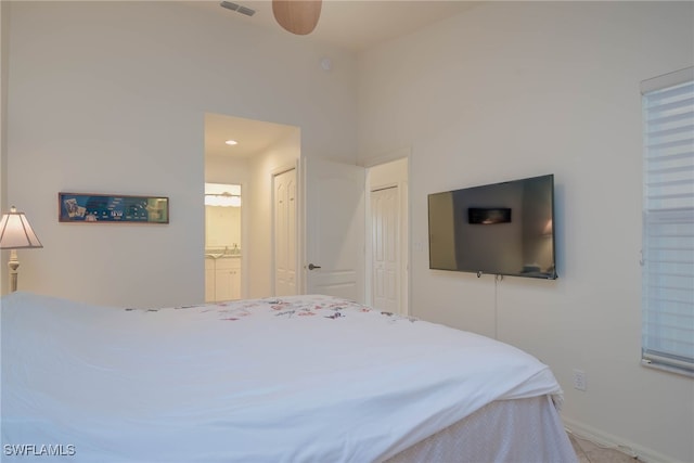 bedroom with ensuite bath and a closet