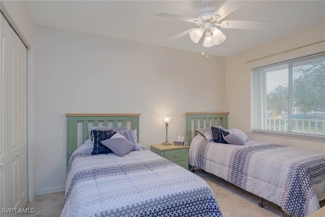 bedroom featuring ceiling fan and a closet