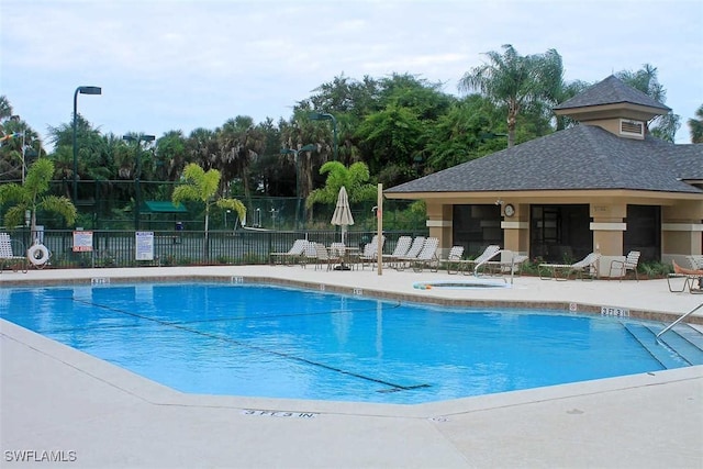 view of swimming pool featuring a patio area and a community hot tub