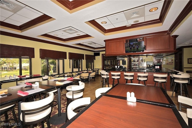 tiled dining room featuring coffered ceiling, crown molding, and bar area