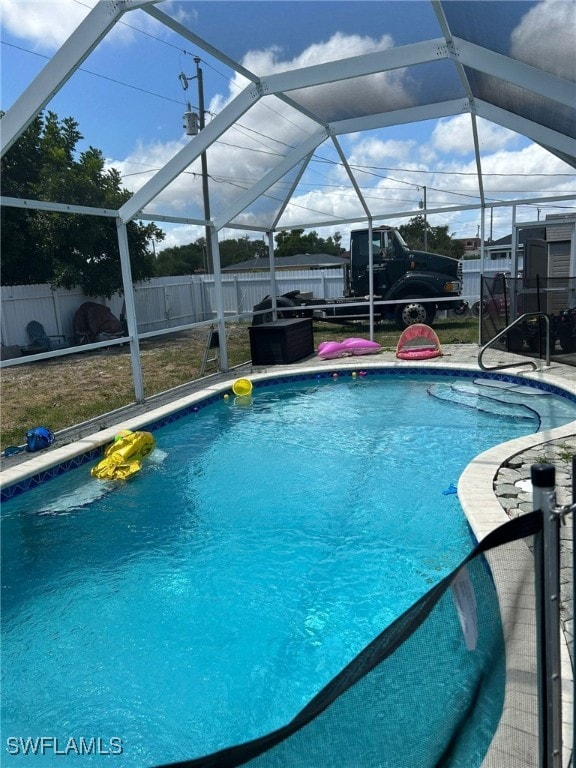 view of swimming pool with glass enclosure