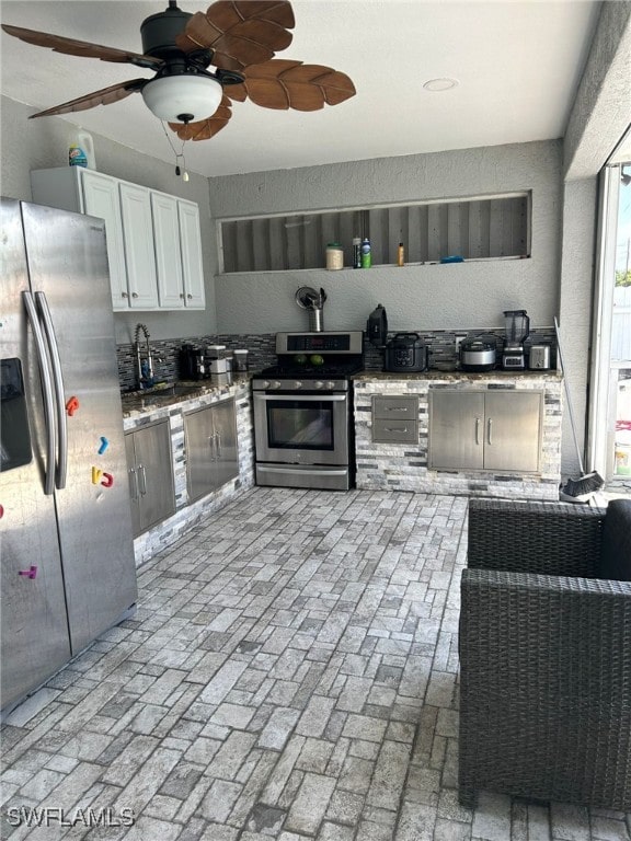 kitchen with white cabinets, ceiling fan, and appliances with stainless steel finishes