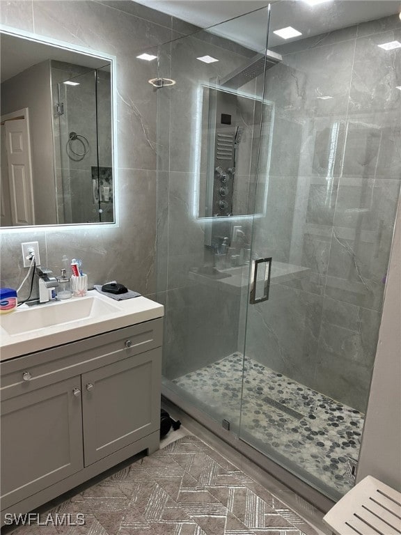 bathroom featuring an enclosed shower, backsplash, and vanity